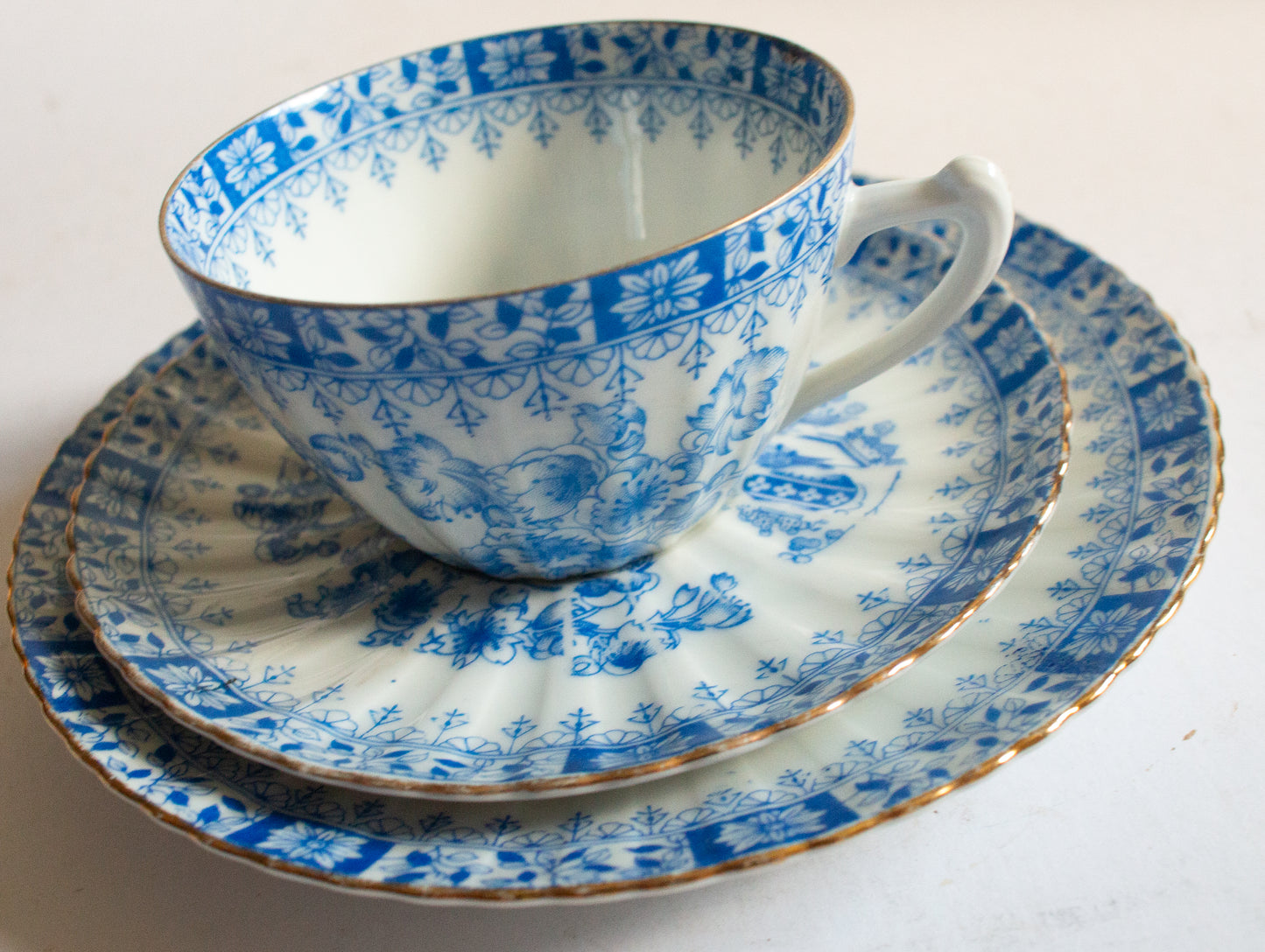 Vintage Blue and White China Teacup Trio with Floral and Gilt Detail