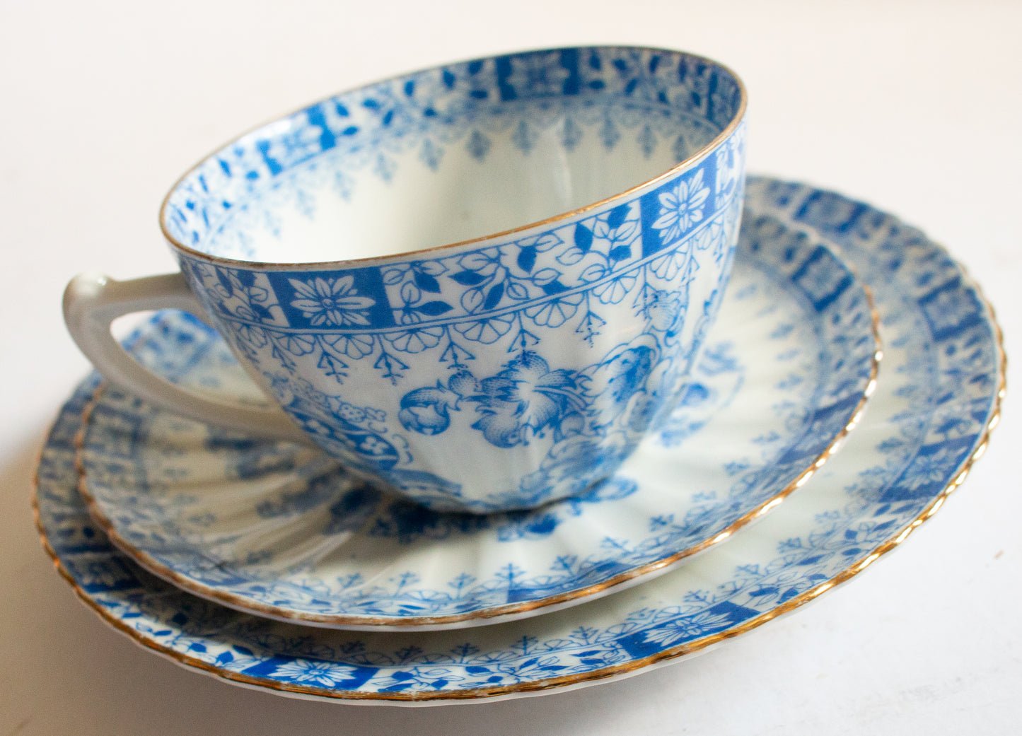 Vintage Blue and White China Teacup Trio with Floral and Gilt Detail