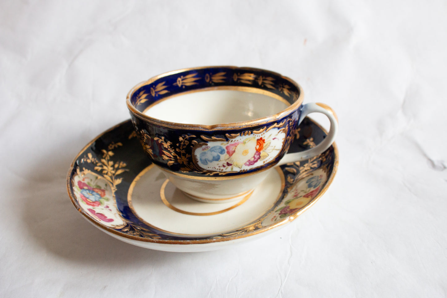 Antique Cobalt and Gold Bone China Teacup and Saucer with Hand painted Floral Detail