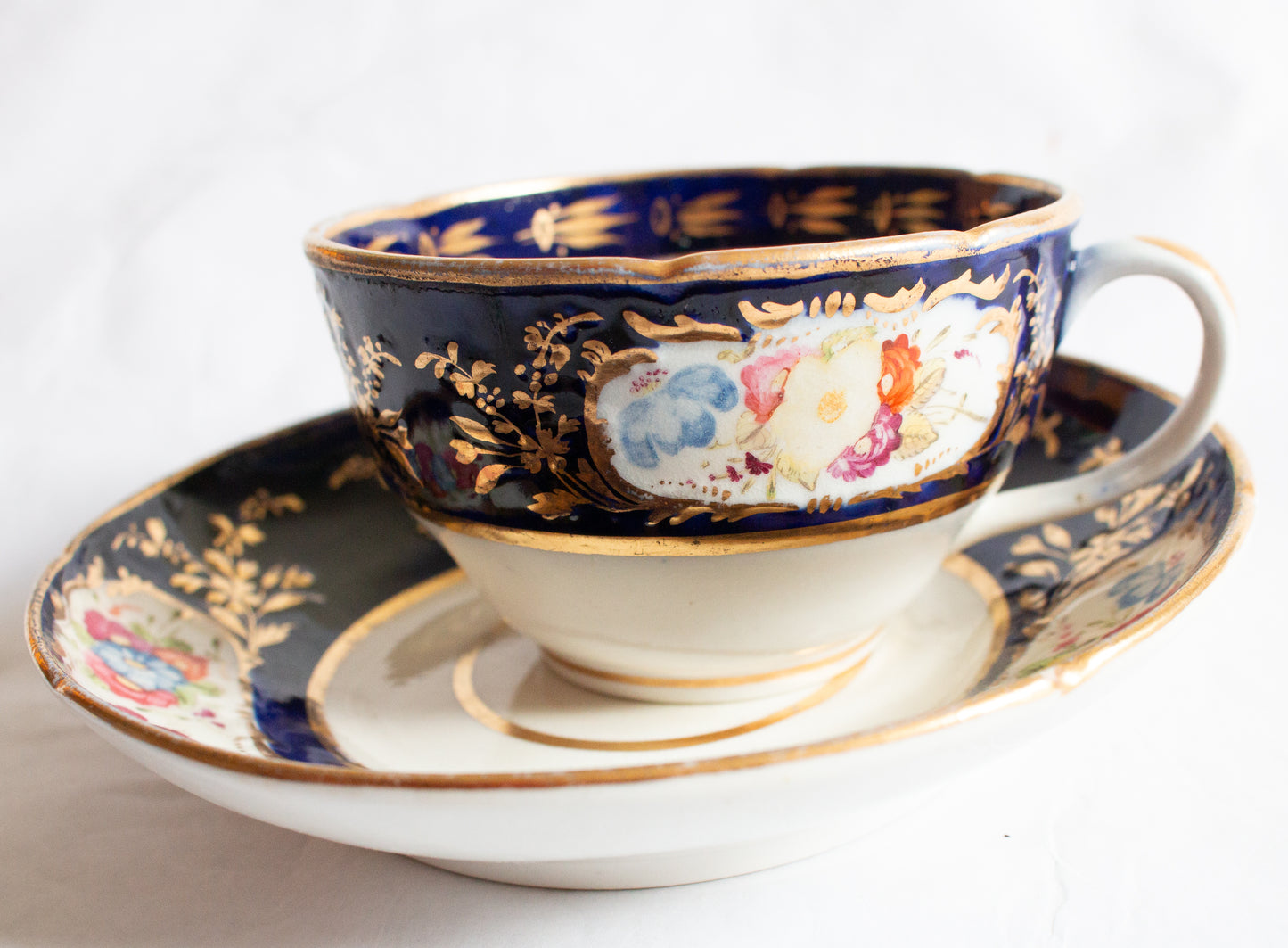 Antique Cobalt and Gold Bone China Teacup and Saucer with Hand painted Floral Detail