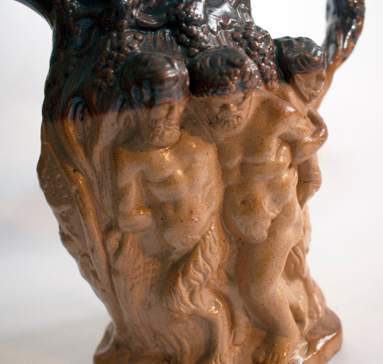 Antique Stoneware Brown Treacle Glazed Jug with Bacchanalian Figures