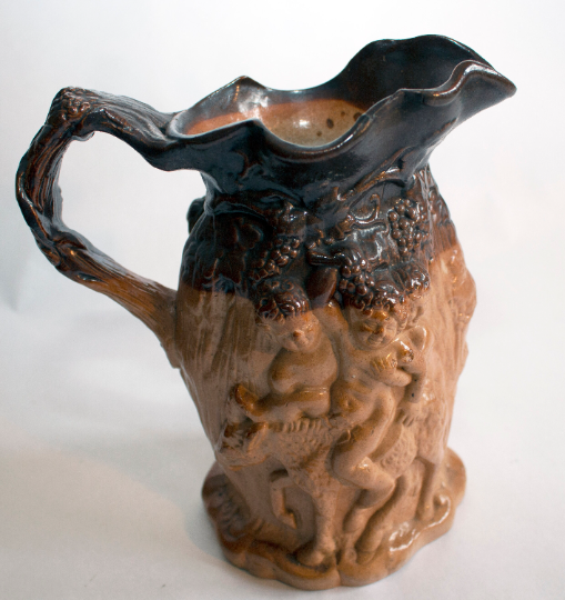 Antique Stoneware Brown Treacle Glazed Jug with Bacchanalian Figures